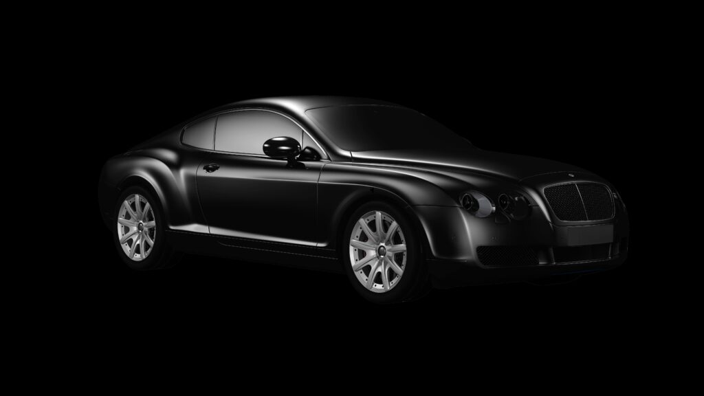 Black luxury car photographed in studio with sleek design and chrome accents.